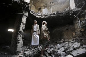 Houthi militants stand in the house of Houthi leader Yahya Aiydh, after Saudi-led air strikes destroyed it in Yemen's capital Sanaa September 8, 2015. REUTERS/Khaled Abdullah